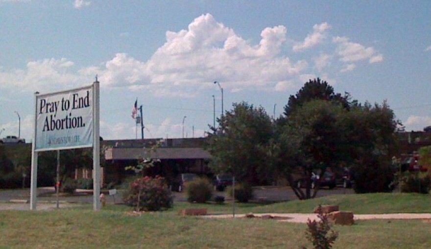 A pro-life sign across the street from Tulsa's Reproductive Services. Reproductive Services is challenging the state law.