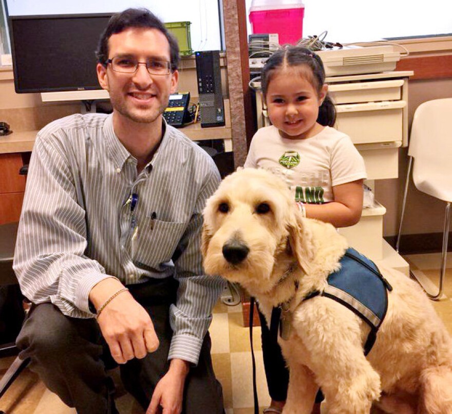 Dr. Evan Los with one of his patients, Sophia, and her diabetes dog St. Nick.