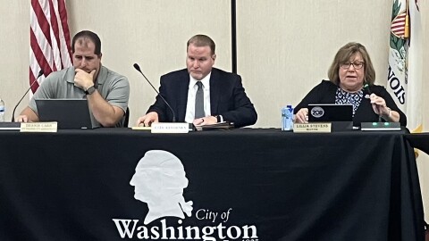Interim City Administrator Dennis Carr (left), City Attorney Mark Walton and Mayor Lilija Stevens gather their thoughts moments before the start of Monday's special Washington City Council meeting.