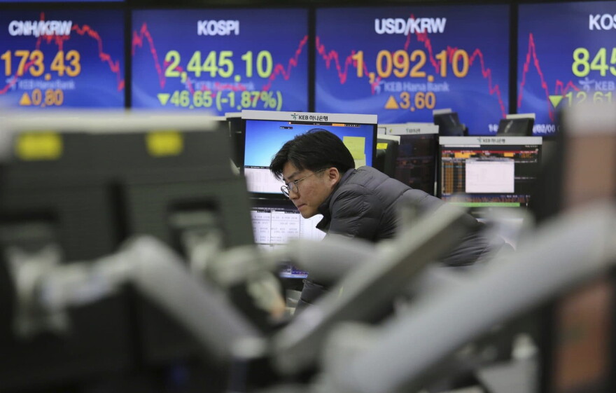A currency trader watches monitors at the foreign exchange dealing room of the KEB Hana Bank headquarters in Seoul, South Korea, Tuesday, Feb. 6, 2018. Shares tumbled in Asia on Tuesday after a wild day for U.S. markets that resulted in the biggest drop in the Dow Jones industrial average in six and a half years. (Ahn Young-joon/AP)