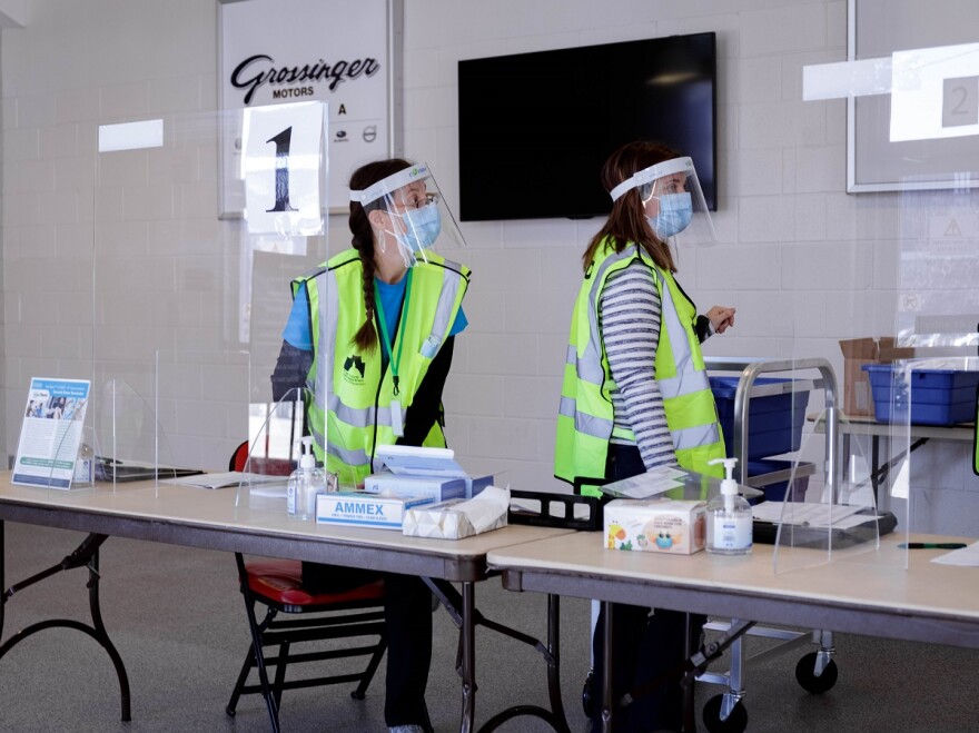 Staff wearing masks and face shields at vaccination clinic