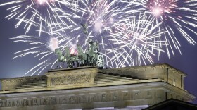 Fireworks light the sky above the Quadriga at the Brandenburg Gate shortly after midnight in Berlin, Germany, Sunday, Jan. 1, 2017.
