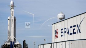 A Falcon 9 SpaceX heavy rocket stands ready for launch on pad 39A at the Kennedy Space Center in Cape Canaveral, Fla., Monday, Feb. 5, 2018. The Falcon Heavy scheduled to launch Tuesday afternoon, has three first-stage boosters, strapped together with 27 engines in all. (AP Photo/Terry Renna)