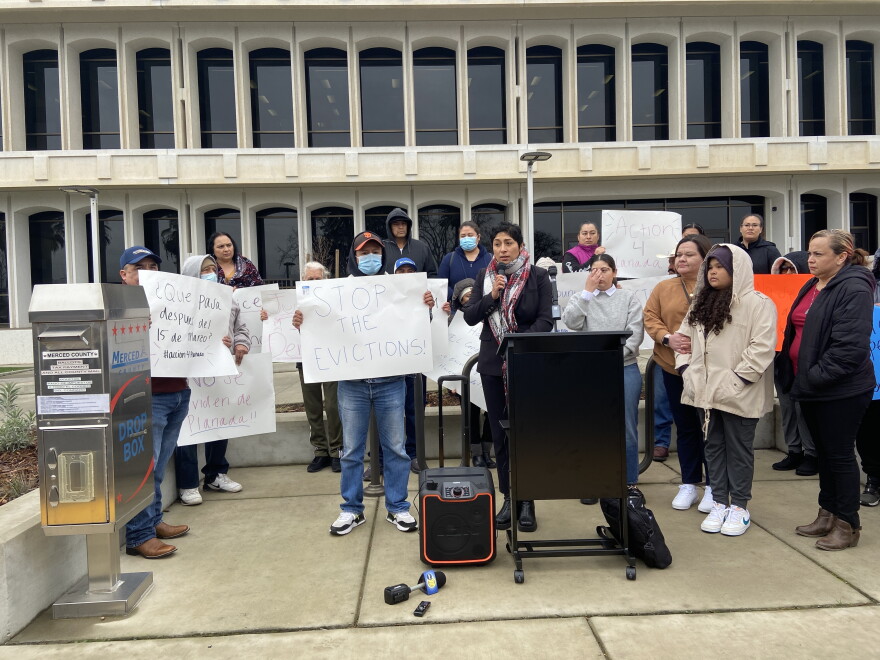 A group of Planada residents rally in front of the Merced County Board of Supervisors to demand a pause on rent and evictions.