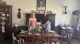 Museum docent Joann Hubert (left) and paranormal investigator Paul Johns (right) with a skeleton friend in the tavern room of the Eagle Tavern Museum in Watkinsville.
