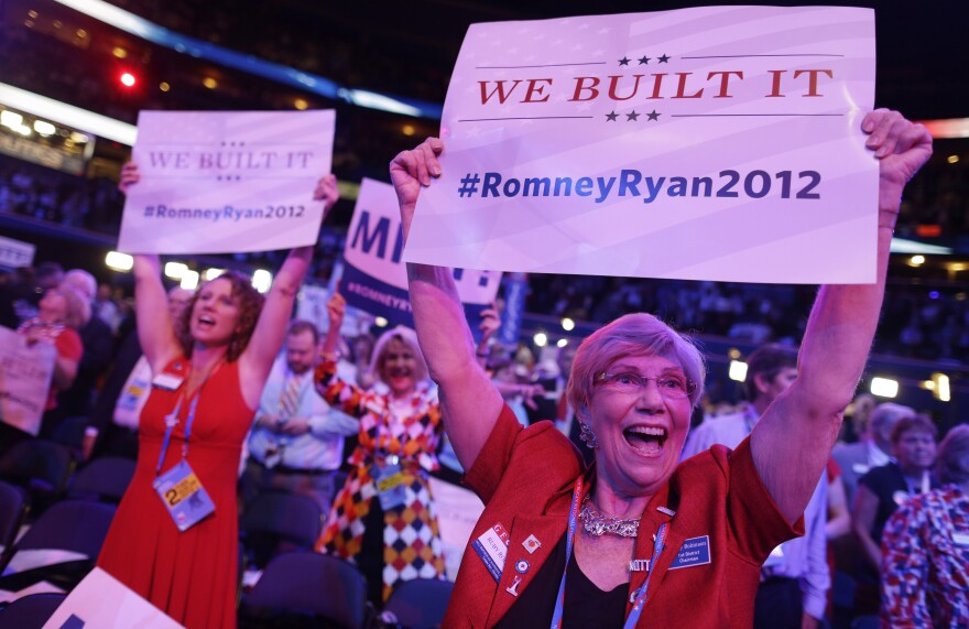 Georgia delegates Ruby Robinson (right) and Kathy Noble hold signs and cheer during the Republican National Convention in Tampa, Fla., where a parade of female officials and officeholders appeared on stage Tuesday.