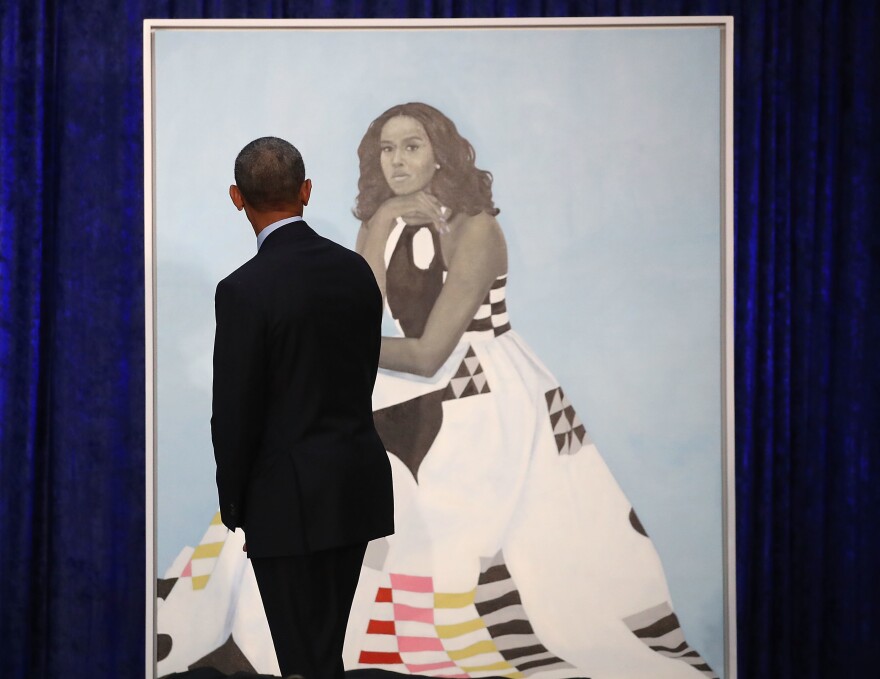 Barack Obama gazes at his wife's newly unveiled portrait on Monday. The painting of Michelle Obama will be on display through November in the National Portrait Gallery's "Recent Acquisitions" section.