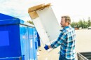 A worker recycling cardboard at a recycle center