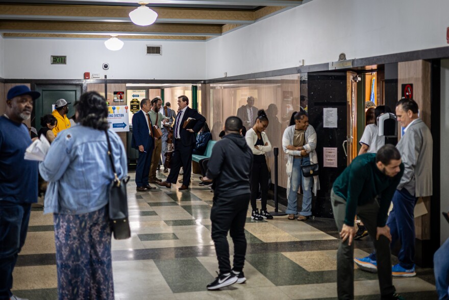 After roll call, tenants, landlords and attorneys meet outside the courtroom.