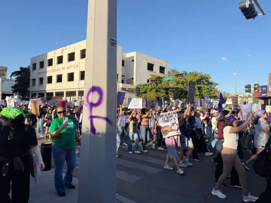 A freshly graffitied purple feminist symbol during Hermosillo's 2026 International Women's Day march.