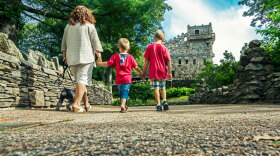 File: A family taking a weekend walk in Gillette Castle State Park in East Haddam, Connecticut on a sunny day.