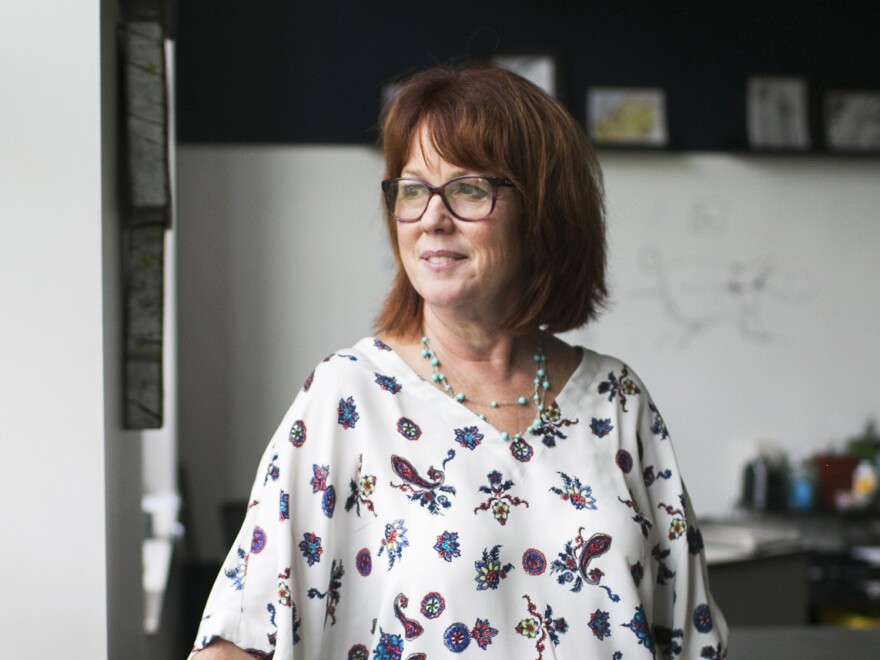 Debbie Kelly, an art teacher at the Global Impact STEM Academy, stands in her classroom. "This is a very exciting, happy place," she says of the revived school. "I think it's just magical."