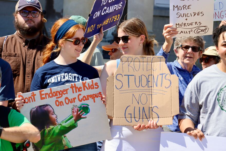 Opponents of barring gun restrictions on college campuses in New Hampshire rally Tuesday before a N.H. Senate hearing on the bill
