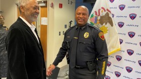 MicroGrants CEO Don Samuels, left, and Bloomington Police Chief Jamal Simington talk following a news conference at the Bloomington Police Department.