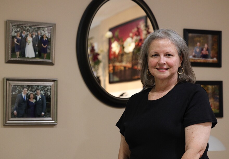 Patty Starr stands in her home for a photo portrait. She says without her support service providers, she doesn't leave her house for much of the week.