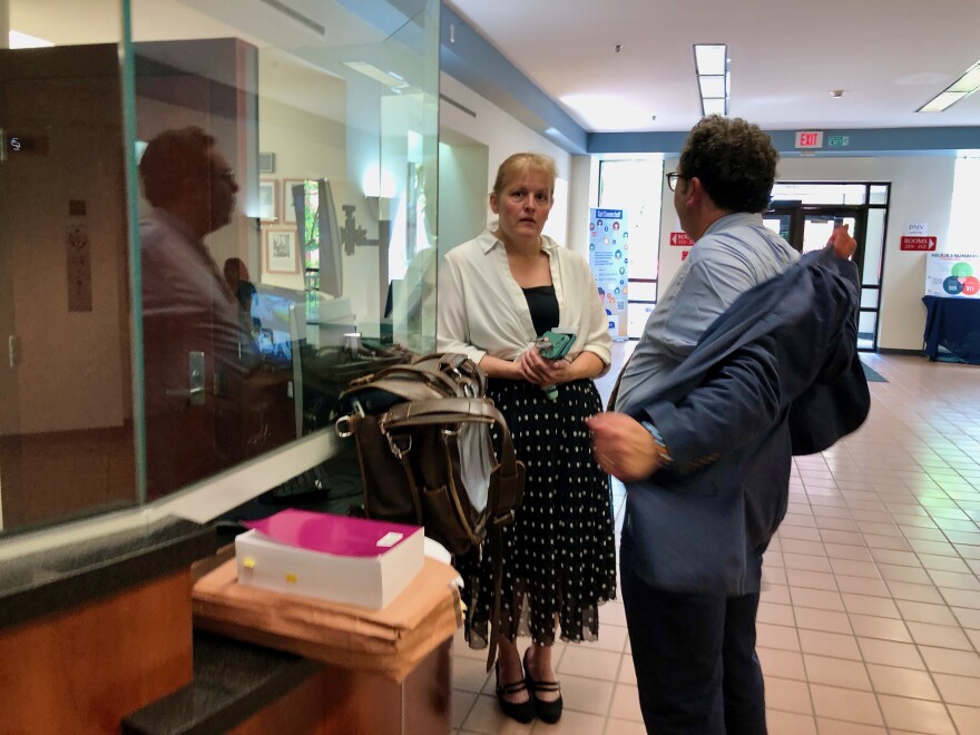 Jenniffer Mullen talks with her attorney at the Steuben County courthouse after her hearing where she pleaded guilty to a felony.