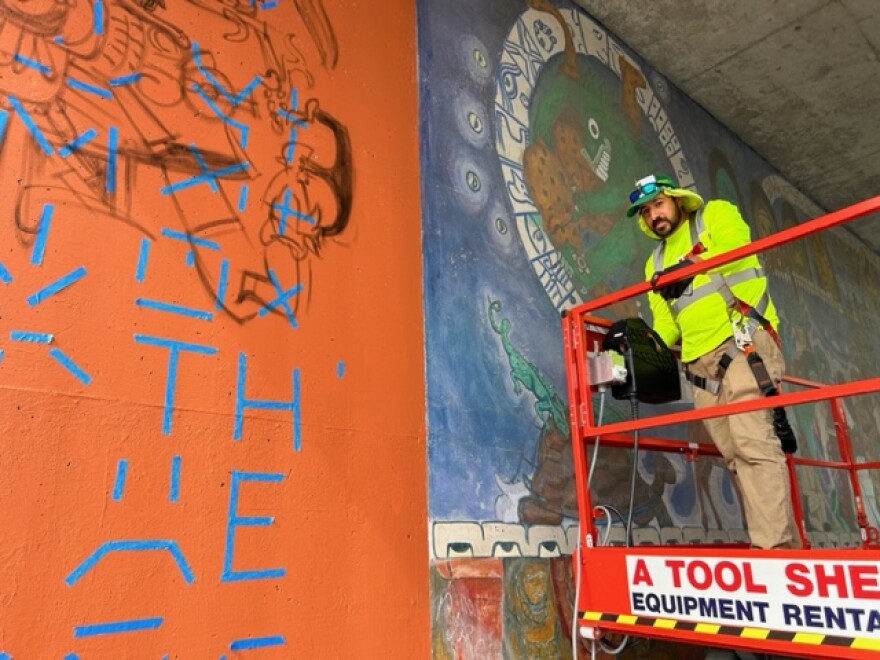 Gerardo Zambrano of La Neta Murals works on a mural in Salinas.