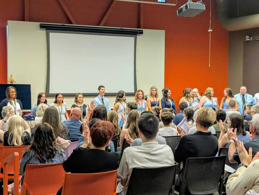 Nursing graduates stand and take a pledge 