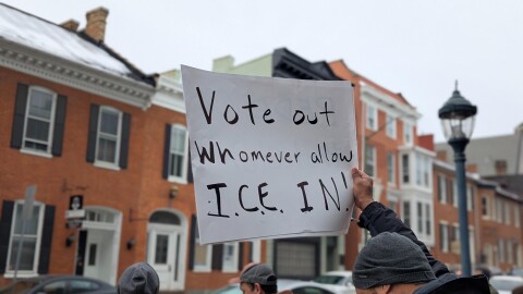 A protester holds up a sign that reads "Vote out whomever allow ICE in!" in Washington County, Md on February 10, 2026.