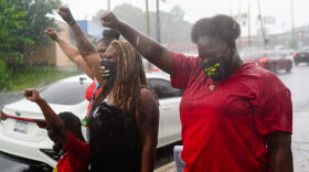 People congregate outside a burned Wendy's restaurant on the second day following the police shooting death of Rayshard Brooks in the restaurant parking lot. 