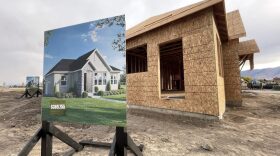 A rendering for a starter home being constructed is on display during a groundbreaking ceremony 