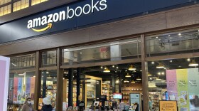 People walk by an Amazon Books store at the Westfield Garden State Plaza shopping mall in Paramus, N.J., on Jan. 10, 2022.