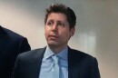 Man with spikier brown hair in a blue suit and tie 