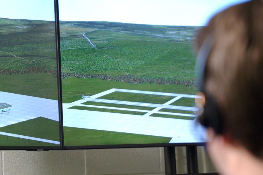 At USU’s air traffic control simulator, students try their hand at directing virtual air traffic displayed on monitors via voice commands to computer software. The simulator helps them learn the complex phraseology and operations aviation requires.