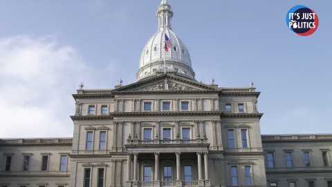 a photo of the Lansing state capitol building in front of a blue sky