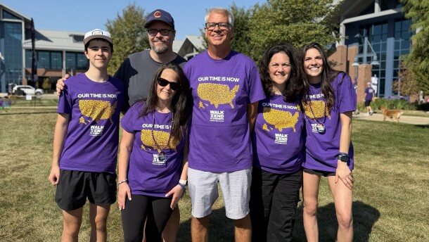 Picture of several people in purple Alzheimer's Association shirts at Heartland Community College event
