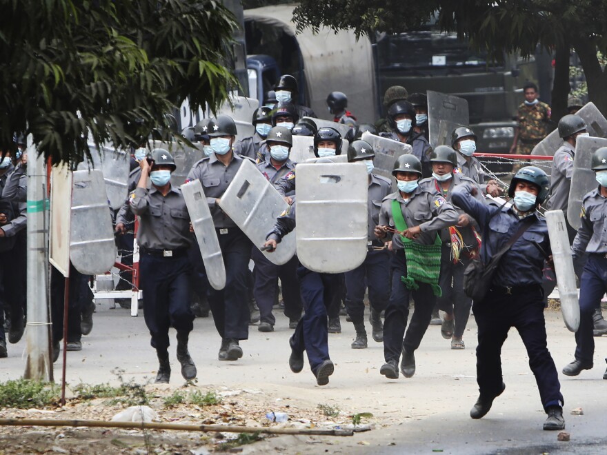 Police charge forward to disperse protesters in Mandalay, Myanmar on Saturday, Feb. 20, 2021. Security forces in Myanmar ratcheted up their pressure against anti-coup protesters Saturday, using water cannons, tear gas, slingshots and rubber bullets against demonstrators and striking dock workers in Mandalay, the nation's second-largest city. (AP Photos)