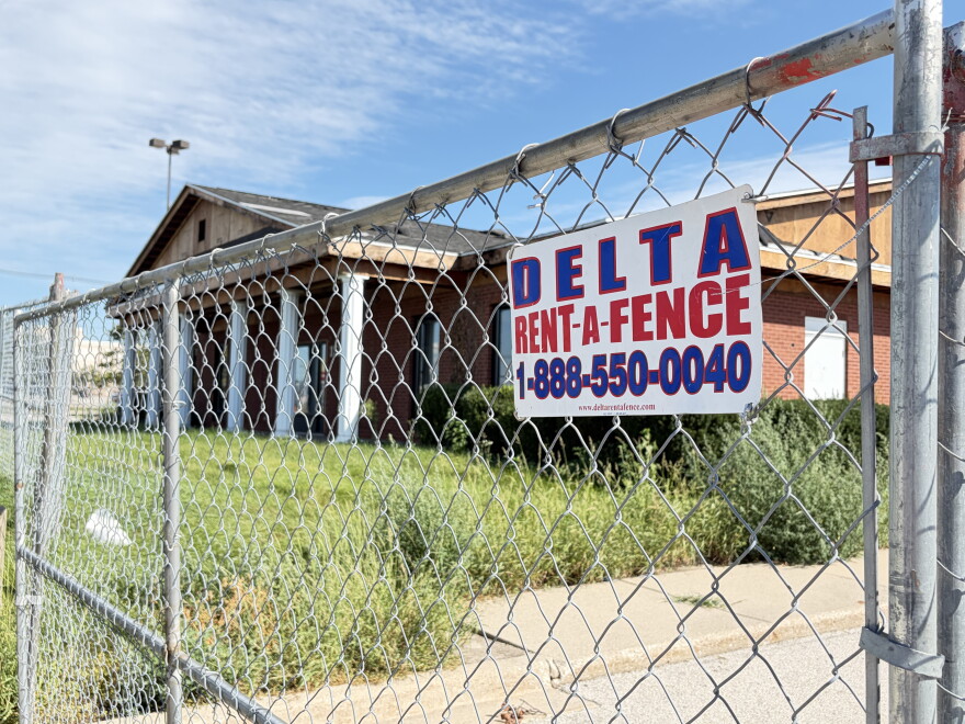 a chain link fence blocks access to a building under construction