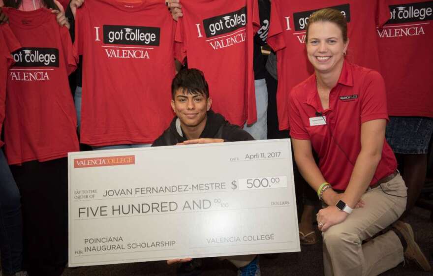 Jovan Fernandez-Mestre, the first student who officially registered for classes at the Poinciana Campus, and President Kathleen Plinske.  The photo was taken at Poinciana High School in April 2017 when Jovan was surprised with a $500 scholarship.