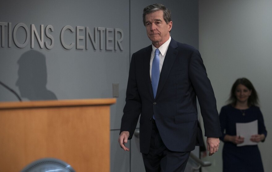 North Carolina Gov. Roy Cooper, left, and state Health and Human Services Secretary Mandy Cohen prepare to give an update on the coronavirus April 30, 2020, in Raleigh.