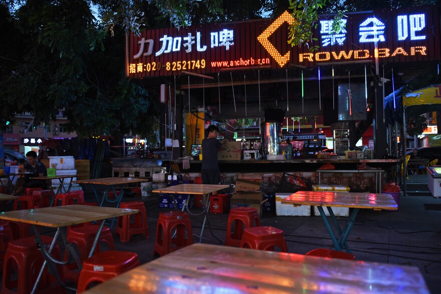 Crowdbar is a food stall in an open-air market in Dongguan, across the street from a factory complex that specializes in making shoes. "Right now, even the smallest vendors can't survive," Crowdbar's owner says.