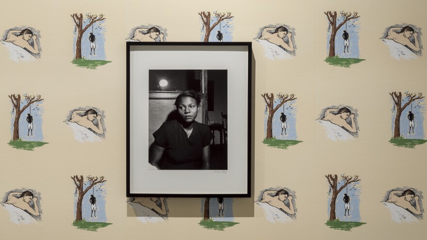 Noah Davis hung a 1949 portrait of the wife of a lynching victim on top of Robert Grober's 1989 <em>Hanging Man/Sleeping Man</em> screen-printed wallpaper.