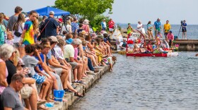 A crowd watches the National Cherry Festival’s Milk Carton Regatta at the Clinch Park Marina Boat Launch on Wednesday morning in Traverse City. Competitors raced boats made from recycled milk cartons on a course just off shore of Clinch Beach.