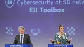 Two European Commission officials, Thierry Breton (left) and Margrethe Vestager (right), give a press conference on 5G security Wednesday in Brussels. The EU recommended that member states screen telecom firms, but did not call for banning any by name. The Chinese telecom Huawei said it welcomed the decision and hopes to take part in building 5G networks in Europe.