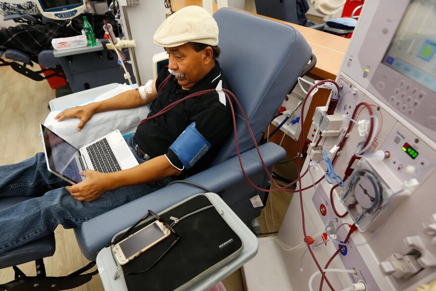 Workers in dialysis clinics will earn at least $23 an hour when California's health care minimum wage takes effect. Here, a patient undergoes dialysis at a DaVita Kidney Care clinic in Sacramento in 2018.