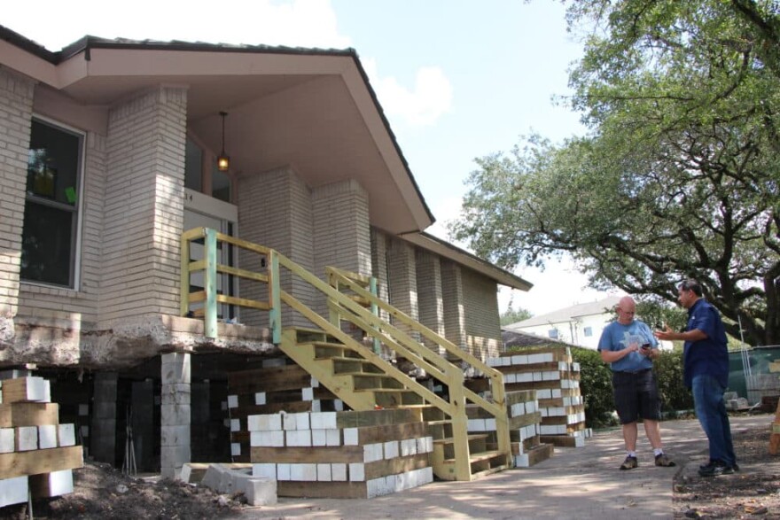 After privately funding his own elevation, Meyerland homeowner Drew Shefman (left) said his home was lifted to nearly 5 feet — one day before Harvey hit. (Allison Lee/Houston Public Media)