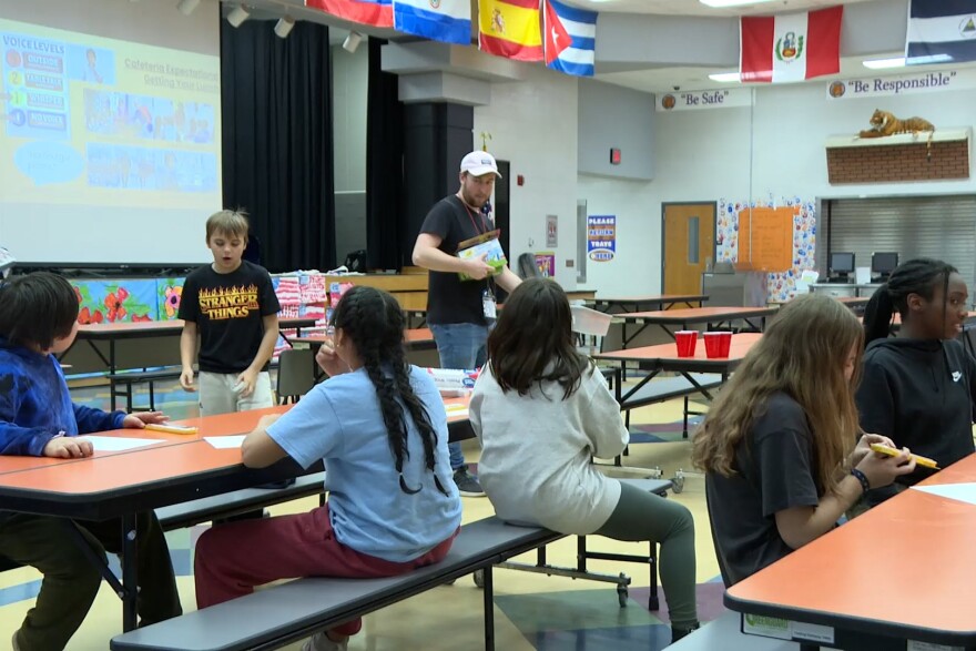 Kids at Templeton Elementary School collect supplies to start a painting activity.
