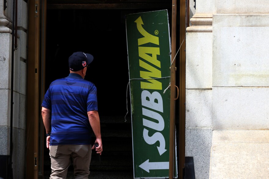 A person walks into a Subway sandwich store on Broadway on August 21, 2023 in New York City. According to reports by the Wall Street Journal, Roark Capital has been competing with a group of rival private-equity firms, that includes TDR and Sycamore, and is closing on a deal to buy the Subway sandwich-shop chain for about $9.6 billion and could be finalized this week. Subway is the eighth-largest U.S. restaurant chain with 20,810 locations which brought in $9.8 billion in domestic sales last year. (Photo by Michael M. Santiago/Getty Images)