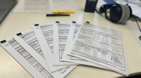 Campaign finance documents spread out on WHQR's somewhat disorganized desk.