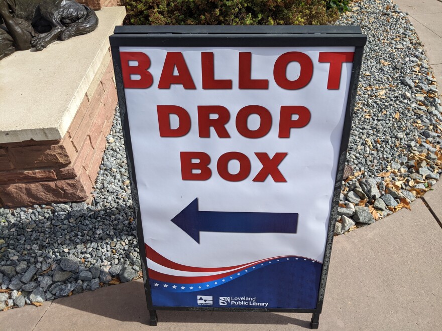 A sign directs voters where to drop their ballots outside the public library in Loveland, Colorado.