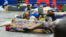 Bobby Joe Edwards, Sr., and his wife Lillie Edwards, of Walkalla, Fla., and their grandson Tavarrious Dixon, rest inside a hurricane evacuation shelter at Fairview Middle School in Leon County, Fla., on Sept. 26, 2024.