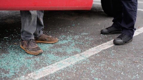 Willy Aceituno, left, makes a police report with Charlotte-Mecklenburg Police Department officer N. Sherill, after U.S. Customs and Border Protection officers broke his window during an enforcement operation, Saturday, Nov. 15, 2025, in Charlotte, N.C.