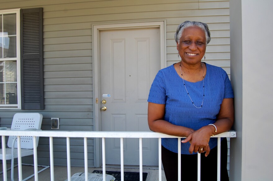 Annie Haigler poses on her front porch in the Park DuValle neighborhood of Louisville. Haigler says she wishes her neighborhood had more trees.