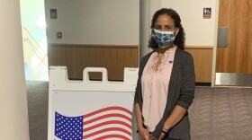 Nicole Miyashiro stands beside a "Vote Here" sign at the State College municipal building.