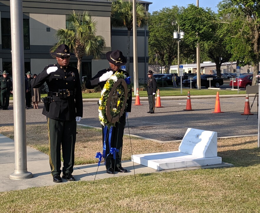 A Sheriff's Department honor guard performed the wreath laying in front of the headquarters building.