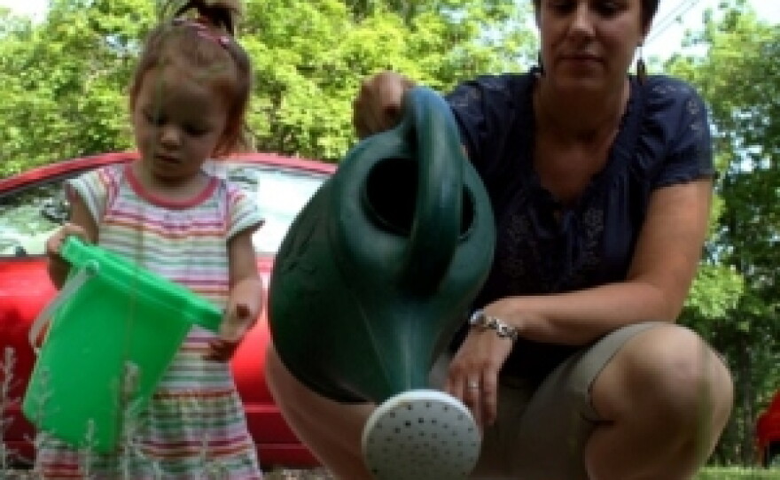 Rebecca Dingo and her daughter, Lucia, play outside of her home in Columbia. Dingo is an assistant professor in MU's English and Women's Studies departments and is taking advantage of the University's clock-stop policy, which allows new parents extra time